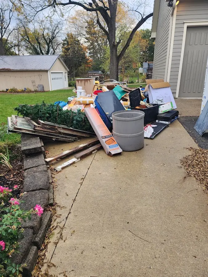 Dumpster being loaded with debris for 12 Yard Dumpster Rental in Lincoln